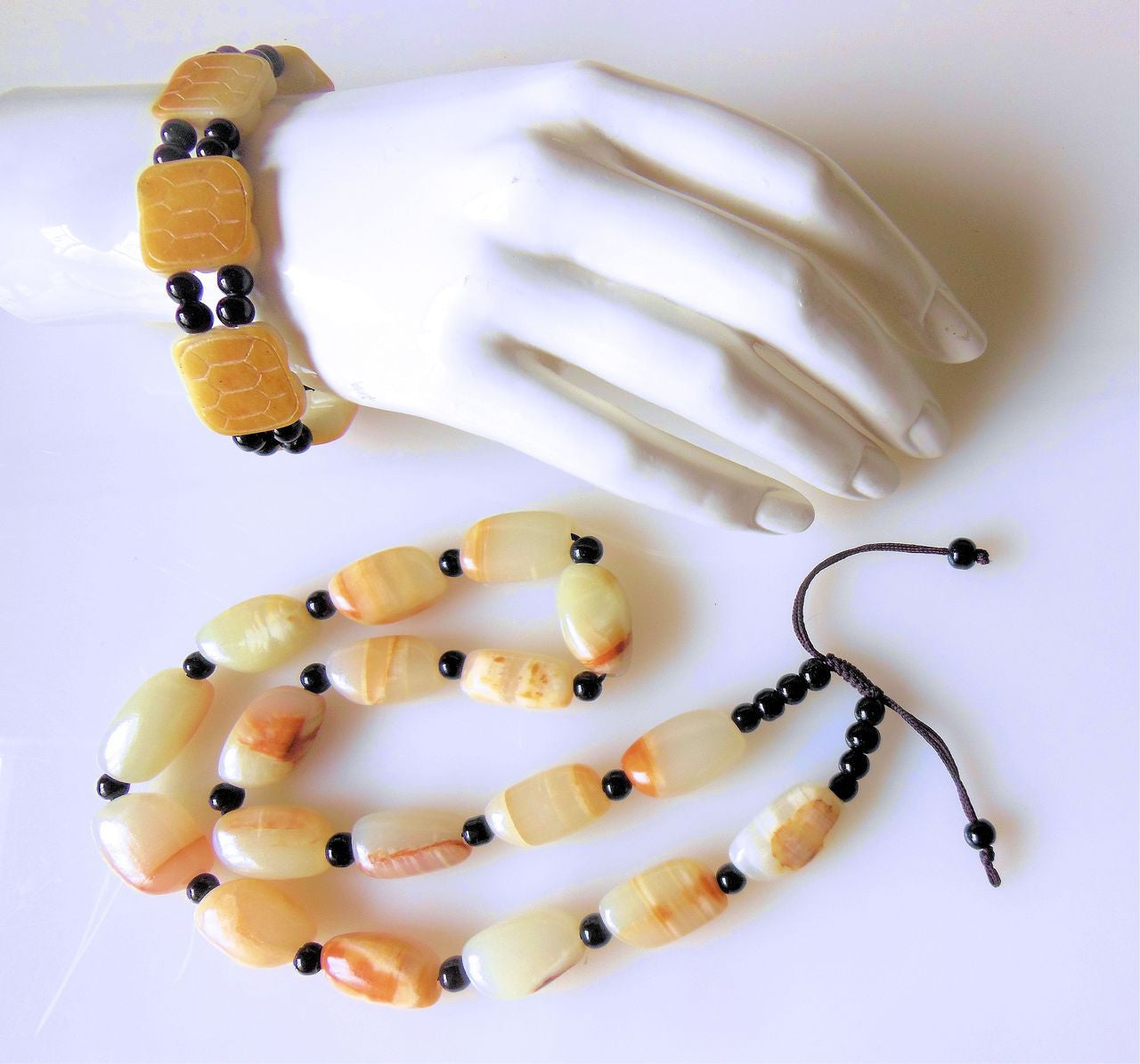 Jade beaded necklace from China.  Black and cream with shades of bronze.-1